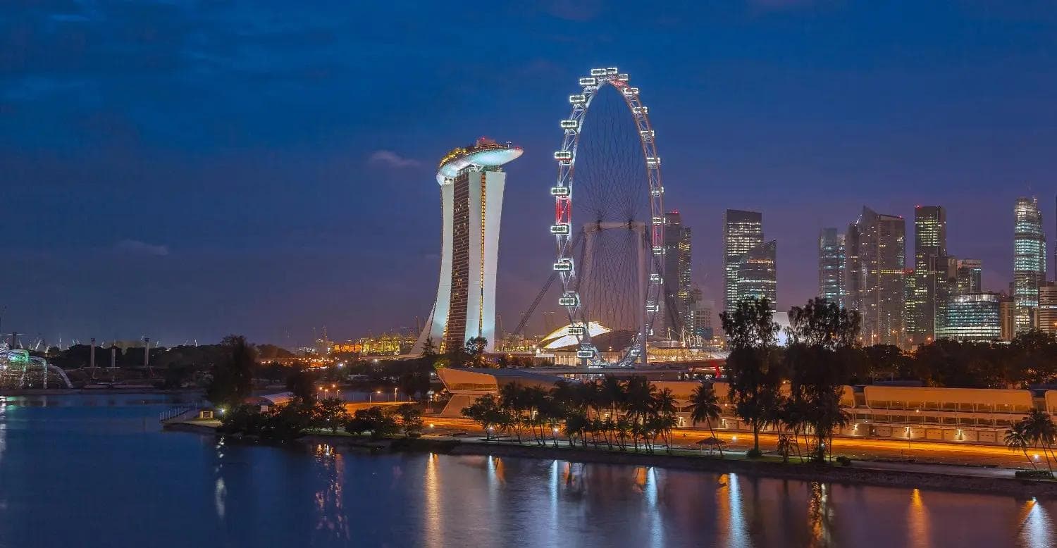 Singapore Night Skyline view featuring the iconic Marina Bay Sands hotel and the illuminated Singapore Flyer. Best city tour.