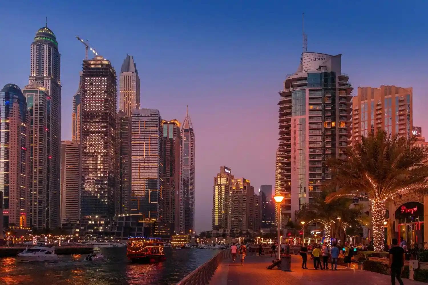 Stunning sunset view of Dubai Marina skyline and waterfront walk. Best Dubai holidays, luxury travel, UAE tour packages for families.