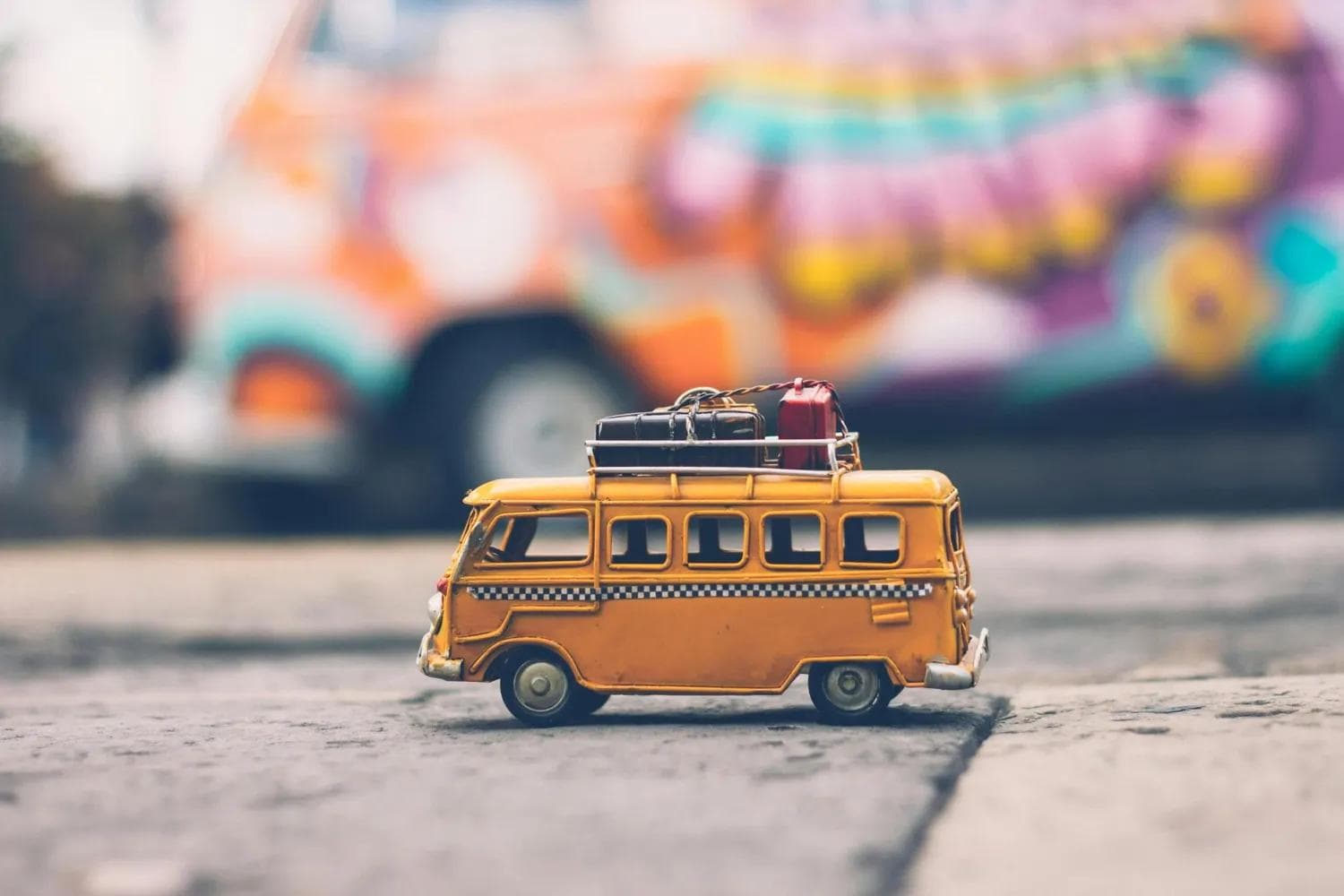 A colorful toy bus carrying luggage, representing travel adventures and weekend getaways from Delhi.